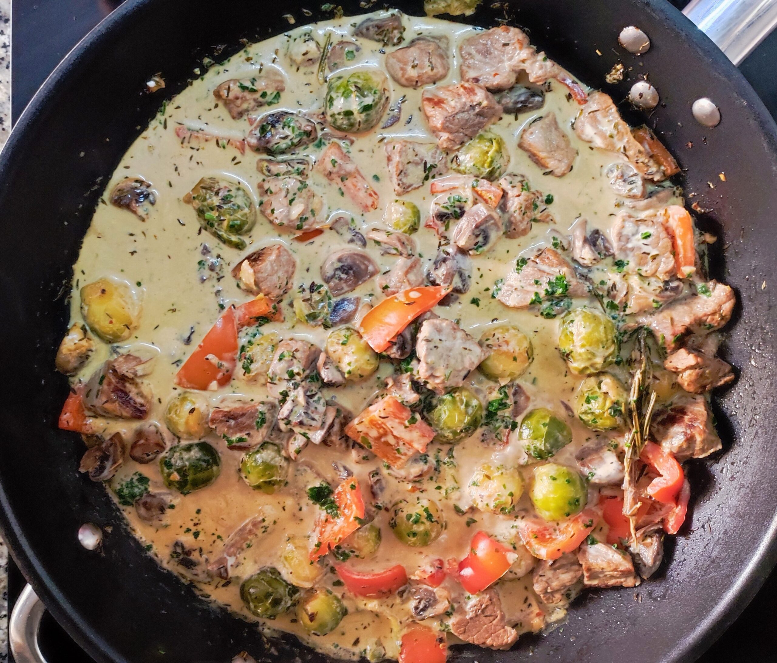 One Pot Beef Stew On The Stove With Mushrooms, Brussels Sprouts, And Bell Peppers